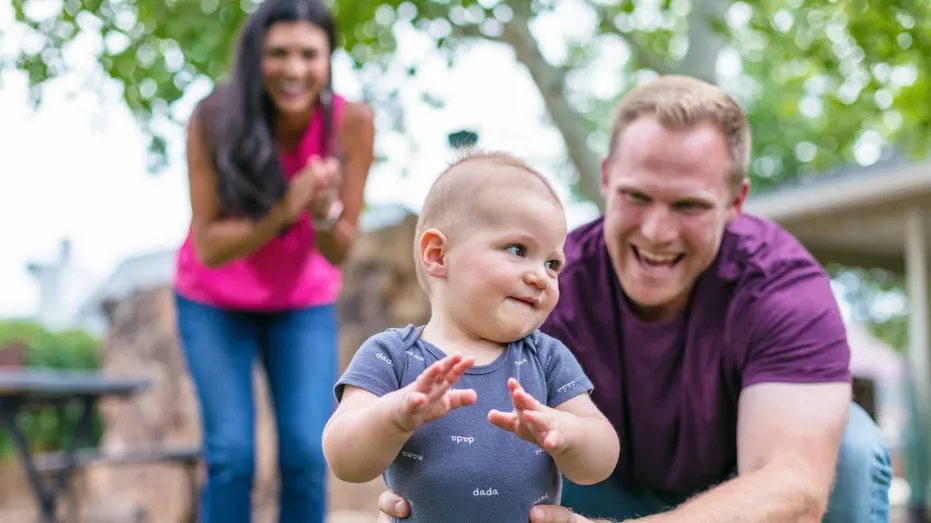 A child playing outside with his family.